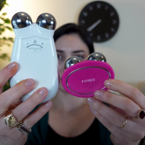 A woman holding the Foreo BEAR device